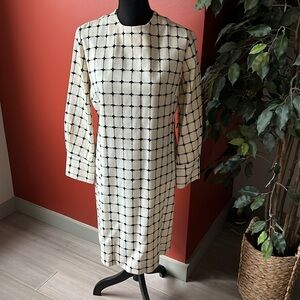 Black and white long sleeve sheath dress with wide cuffs and optional self belt